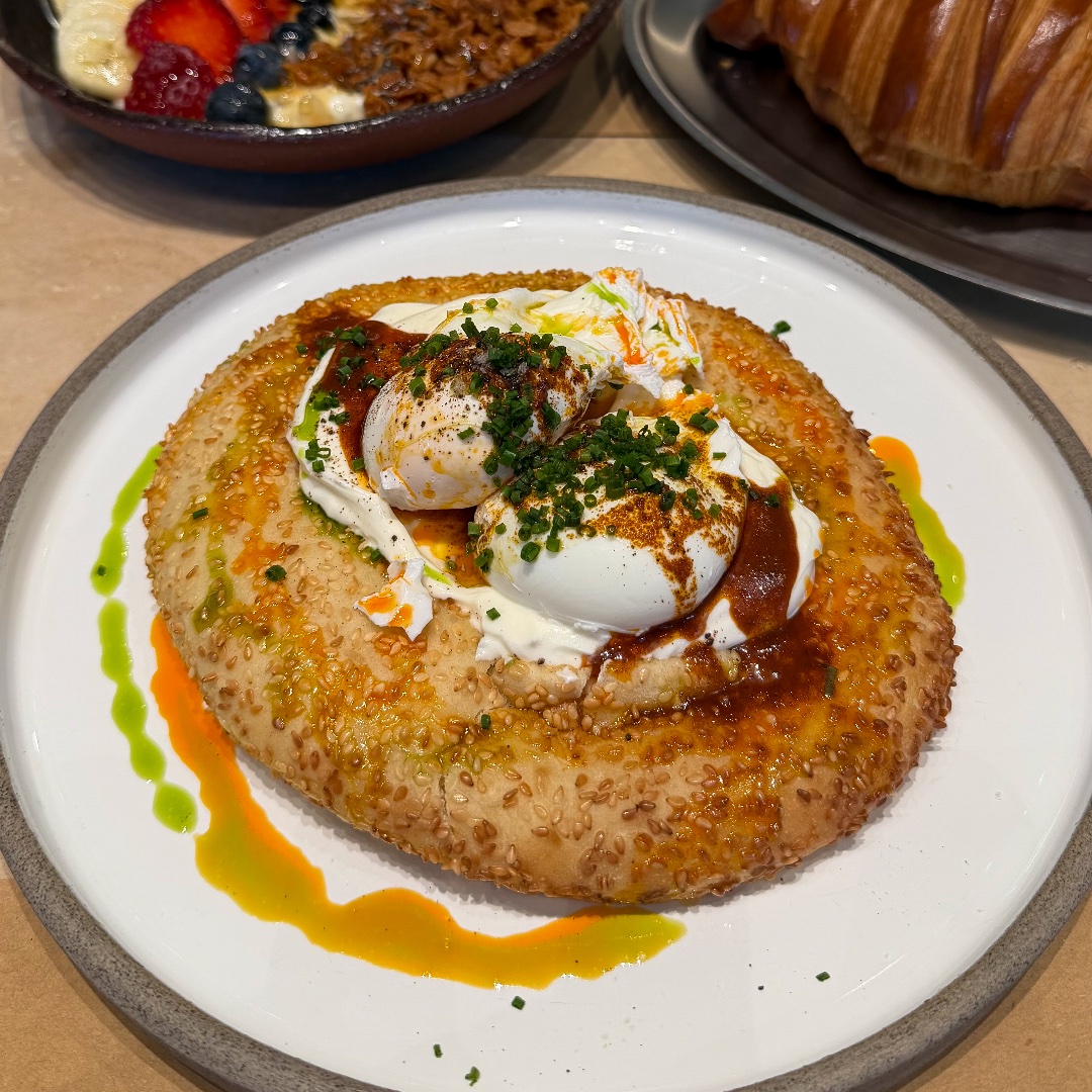 Poached Eggs on Sesame "Koulouri" Bagel with Yogurt & Spicy Butter at ERGON Agora, Downtown Dubai